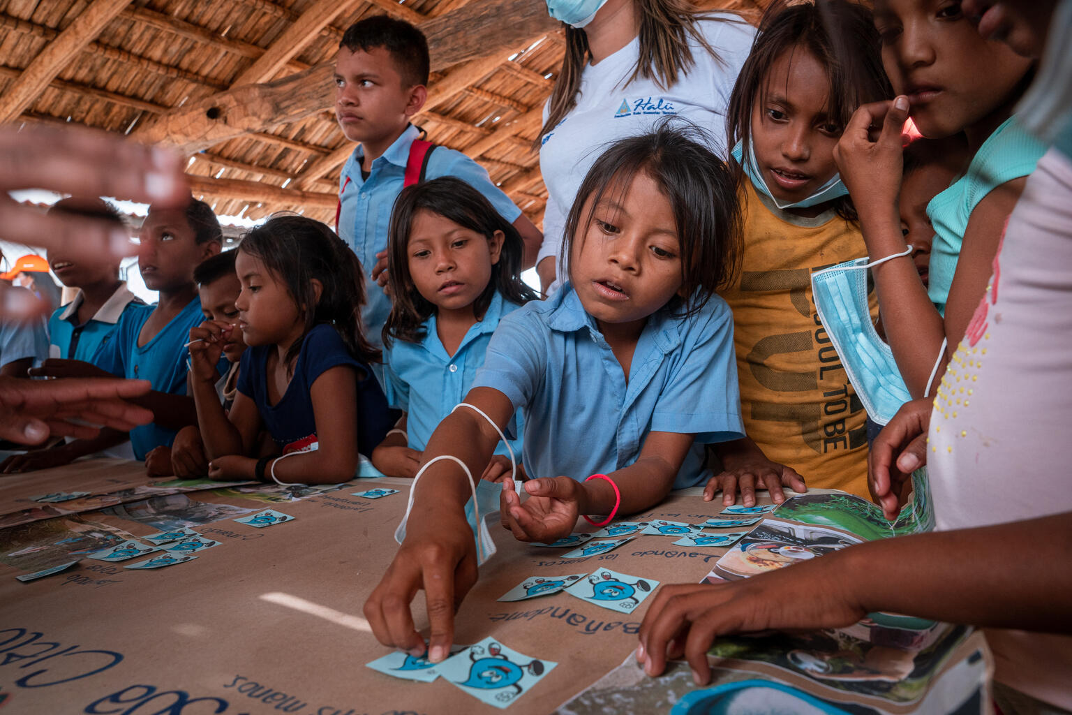 School children working at a table and discussing clean water.